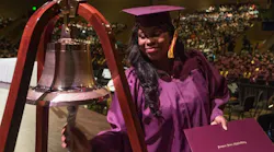 Apprentice Tiffani Brown Powell rings the Apprentice School bell as she graduates