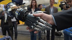 A robot shakes hands with a human at Hannover Messe 2015 A robot shakes hands with a human at Hannover Messe 2015