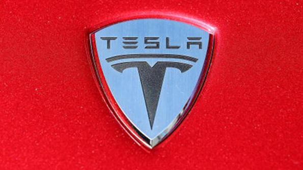 The Tesla logo on the hood of a car