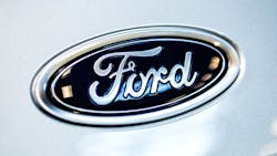 Ford script logo on a car hood Ford script logo on a car hood