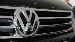 The Volkswagen logo on a car grille The Volkswagen logo on a car grille