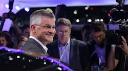 Volkswagen U.S. CEO Michael Horn is surrounded by cameras and reporters after presenting at the 2015 Los Angeles Auto Show.