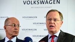 VW supervisory board members Berthold Huber, left, and Stephan Weil address the media at a September news conference.