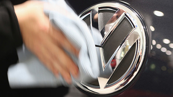 The Volkswagen logo on the front of a car