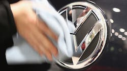 The Volkswagen logo on the front of a car The Volkswagen logo on the front of a car