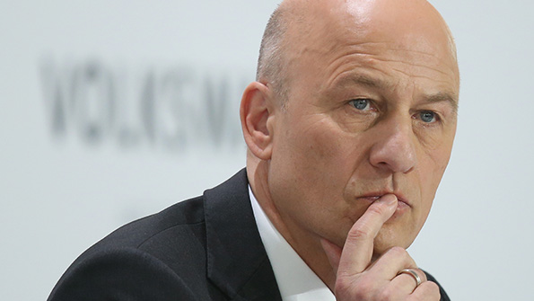 VW CFO Frank Witter listens to a question at a news conference