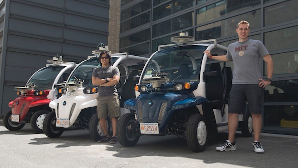 MIT students Justin Miller and Wally Wibowo of the Aerospace Controls Lab work on vehicles outfitted with sensors that match those of selfdriving cars