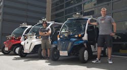 MIT students Justin Miller and Wally Wibowo of the Aerospace Controls Lab work on vehicles outfitted with sensors that match those of self-driving cars.