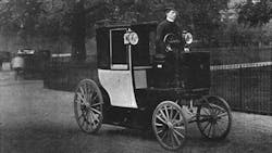 An 1899 electric cab drives through London An 1899 electric cab drives through London