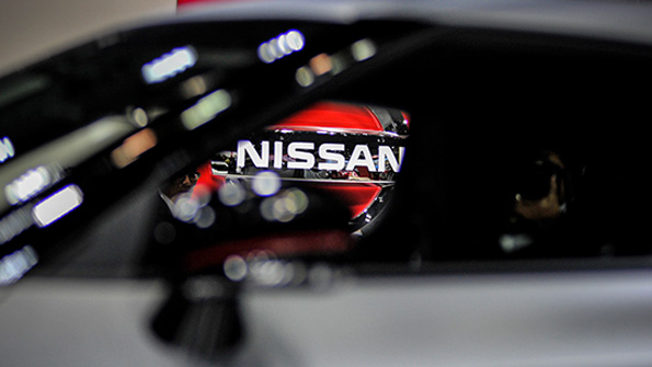 The Nissan logo as seen through a car window at the 2013 Tokyo Motor Show