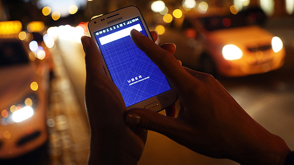 A prospective Uber user opens the companys app on a smartphone