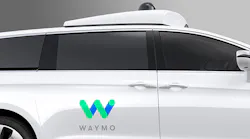 The Waymo logo on the side of a minivan