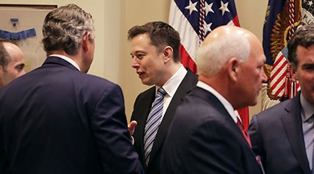 Tesla Motors CEO Elon Musk, center, talks with White House Senior Adviser Stephen Miller, far left, and Arconic CEO Klaus Kleinfeld, second from left, before a Monday meeting with President Donald Trump.