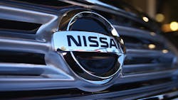 The Nissan logo on a vehicle grille The Nissan logo on a vehicle grille