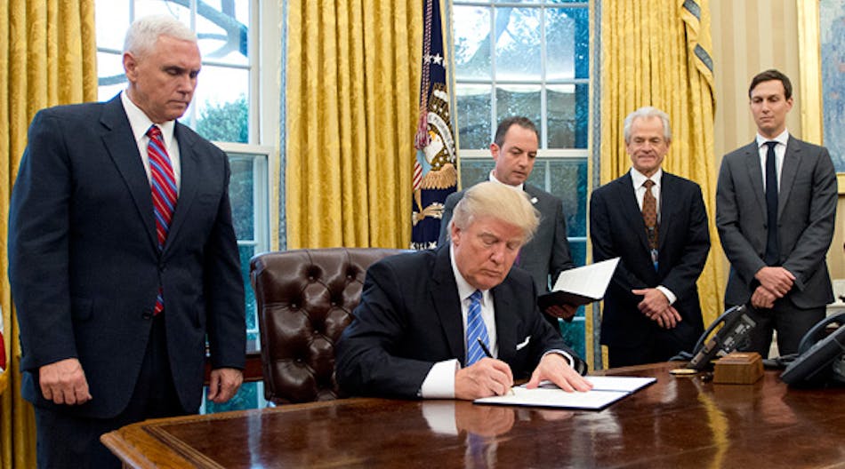 Donald Trump signs an executive order in January concerning the withdrawl of the U.S. from the Trans-Pacific Partnership. National Trade Council director Peter Navarro, second from right, looks on along with VP Mike Pence, chief of staff Reince Preibus, and senior adviser Jared Kushner.
