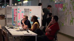 A team of software engineers attend a SCRUM meeting at GE Digital39s San Ramon CA headquarters A team of software engineers attend a SCRUM meeting at GE Digital39s San Ramon CA headquarters