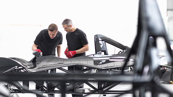 A pair of Briggs employees work on a technologicallyadvanced automobile frame