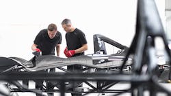 A pair of Briggs employees work on a technologicallyadvanced automobile frame A pair of Briggs employees work on a technologicallyadvanced automobile frame