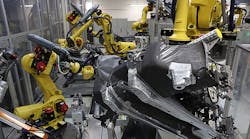 Industrial robots weld portions of the undercarriage of Volkswagen Golf cars at the Volkswagen car factory in Wolfsburg, Germany.