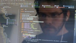 A computer user looks at a screen filled with code A computer user looks at a screen filled with code