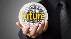Person holding fortune tellers ball with years printed on its surface