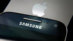 A Samsung and an Apple smartphone, stacked in a pile.