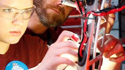 A high school student works on a robot as part of the FIRST Tech Challenge. A high school student works on a robot as part of the FIRST Tech Challenge.