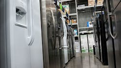 A row of refrigerators inside a big box store. A row of refrigerators inside a big box store.