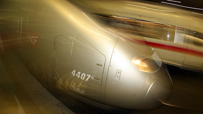 A high-speed TGV train hurtles into a station in Germany.