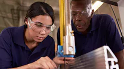 female carpenter apprentice near saw