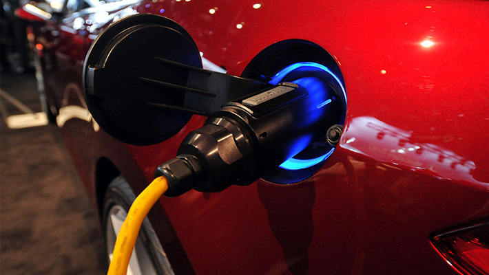 A Tesla pulgs in at the North American International Auto Show in Detroit.