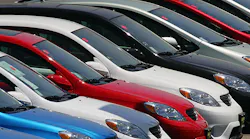 A row of Toyota sedans on a dealership lot.