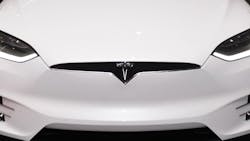 The Tesla Model X with open gull-wing doors. The Tesla Model X with open gull-wing doors.