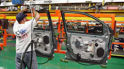 A worker assembles car doors at a Ford plant in Chicago.
