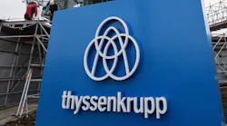 The ThyssenKrupp logo and wordmark in front of a German elevator testing tower