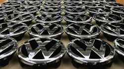 A tabletop of VW hood ornament logos.