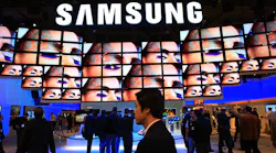 A wall of screens beneath a Samsung logo at a trade show.