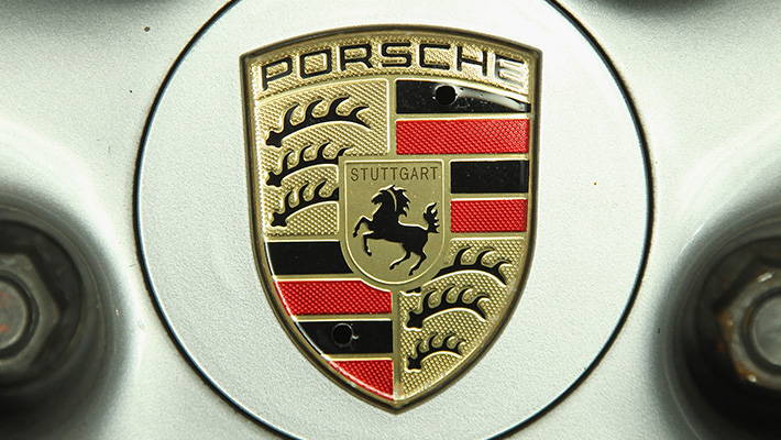 The Porsche logo on a car wheel.