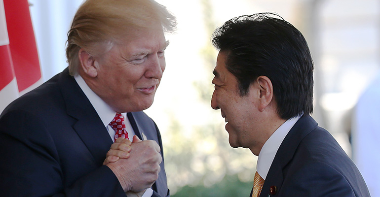 Trump and Japan Prime Minister Shinzo Abe shake hands