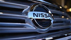 The Nissan logo on the front grille of a vehicle. The Nissan logo on the front grille of a vehicle.