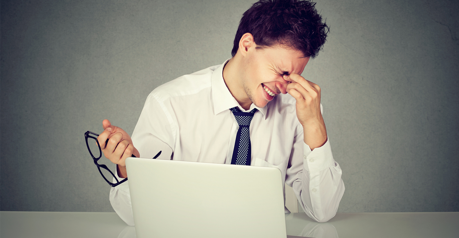 Worker rubbing eyes due to lack of sleep