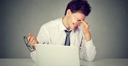 Worker rubbing eyes due to lack of sleep Worker rubbing eyes due to lack of sleep