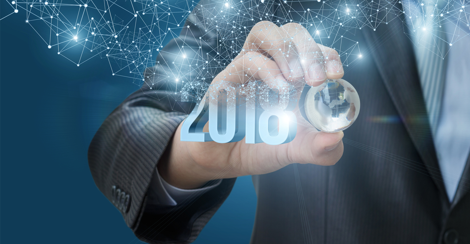 Hand holding crystal globe with 2018