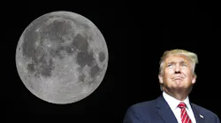 President Donald Trump looks up at the Moon.