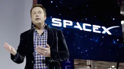 Elon Musk next to SpaceX logo