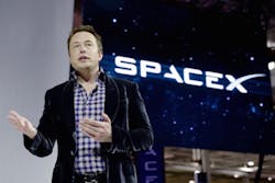 Elon Musk next to SpaceX logo Elon Musk next to SpaceX logo