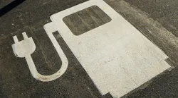 An electric vehicle symbol in a parking lot.