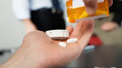 Office worker holding pills