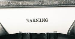 warning on a typewriter warning on a typewriter