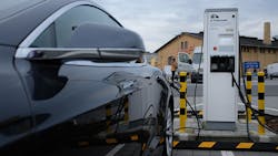 A Tesla sedan charges at a station in Berlin, Germany. A Tesla sedan charges at a station in Berlin, Germany.